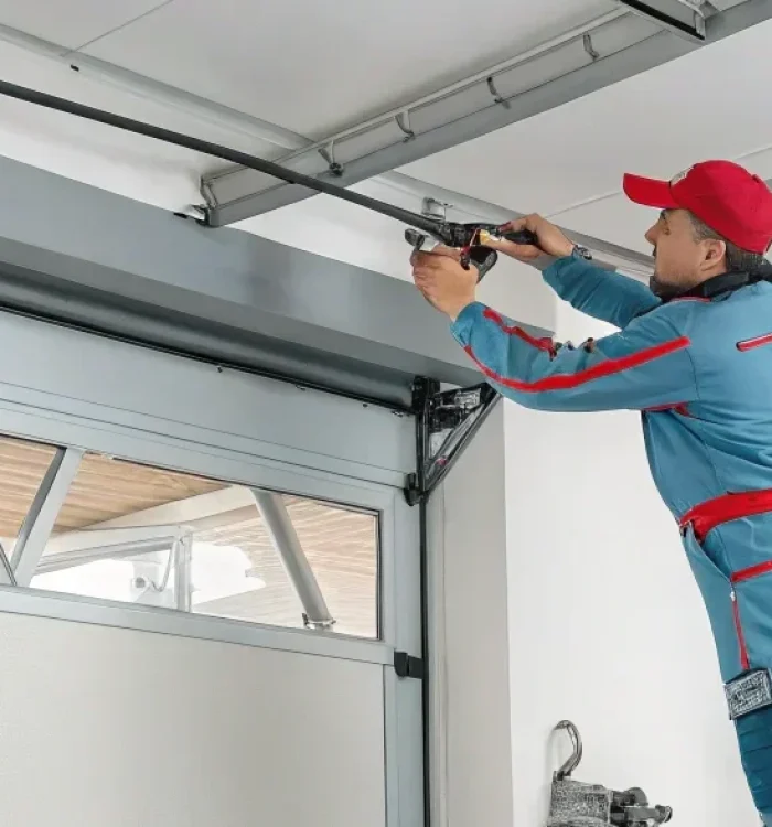 1-technician-adjusting-garage-door-opener-prom-1 1-technician-adjusting-garage-door-opener-prom-1
