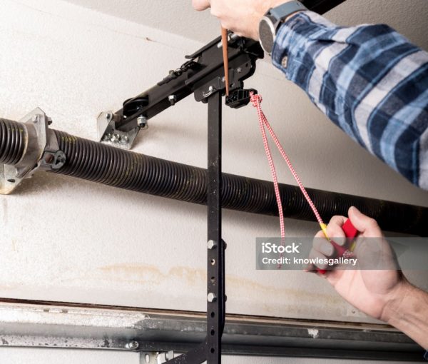 Metal can of oil is used to lubricate a release leaver for a garage door Metal can of oil is used to lubricate a release leaver for a garage door